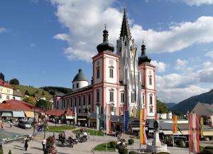 a large building with a tower on top of it at Stadtzentrum Mariazell in Mariazell