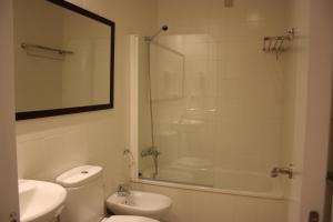 a bathroom with a toilet and a sink and a shower at Apartamentos Playa Barbate in Barbate