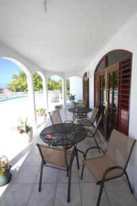 a balcony with a table and chairs on it at Sea View Chateau in Montego Bay