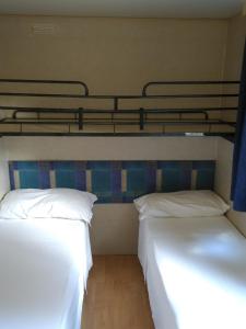 two beds in a room with two bunk beds at Campeggio Lao in Scalea