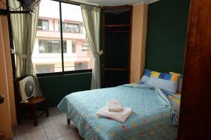 Hostal Puyo客房内的一张或多张床位