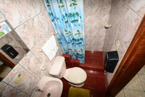 普约Hostal Puyo的浴室设有2个卫生间和蓝色的浴帘