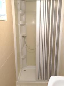 a white shower in a bathroom with a toilet at Campeggio Lao in Scalea