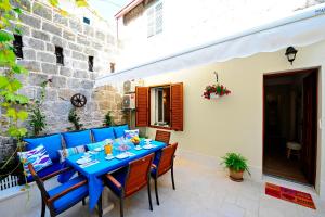 a blue table and chairs on a patio at Luxury Apartment Dvor in Split