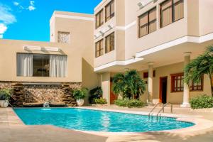 a swimming pool in front of a building at Hotel Majestic in Barranquilla