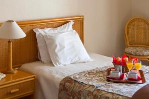 a hotel room with a bed with a tray of drinks at Alte Hotel in Alte +26 photos