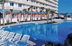 a swimming pool with chairs and a hotel at Harbour Beach Resort Studios! in Daytona Beach
