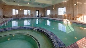 a large swimming pool in a hotel room at Best Western Inn & Suites - Henrietta in Henrietta