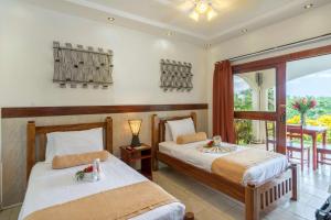 En eller flere senger på et rom på Best Western Tamarindo Vista Villas