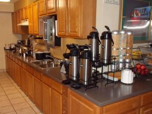 a kitchen counter with a bunch of pots and pans at Best Western Executive Inn in Hallettsville