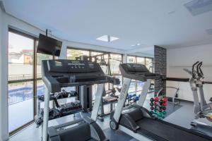 a gym with two tread machines and a treadmill at Samba Rio Convention & Residence in Rio de Janeiro