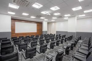 an empty lecture room with black chairs and a whiteboard at Samba Rio Convention & Residence in Rio de Janeiro