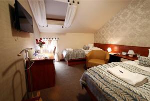 Łóżko lub łóżka w pokoju w obiekcie Hotel Roudna