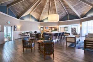 a living room with a vaulted ceiling and a dining room at Best Western On The Bay Inn & Marina in Miami Beach