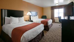 a hotel room with two beds and a flat screen tv at Best Western Campbellsville Inn in Campbellsville