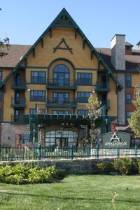 a large building with a fence in front of it at The Appalachian at Mountain Creek in Vernon