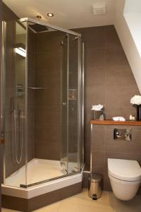 a bathroom with a shower and a toilet at Maitrise Hotel Maida Vale - London in London