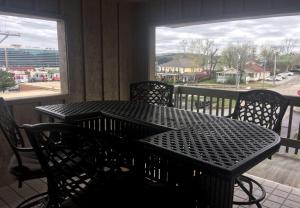 a dining room table and chairs in front of a window at Best Western Plus Landing View Inn & Suites in Branson