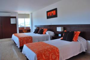 Postel nebo postele na pokoji v ubytování Hotel Hacaritama Colonial