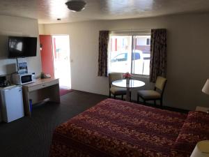 a hotel room with a bed and a table at Old Marina Inn in Marina