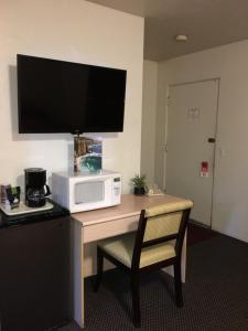 a microwave sitting on a desk with a microwave oven at Old Marina Inn in Marina
