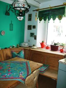 a kitchen with a wooden table and a window at Ferienwohnung Örtl 7 in Obernzell