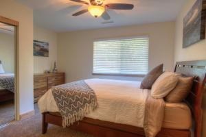 a bedroom with a bed and a ceiling fan at Prestigious Home South Lake Tahoe in South Lake Tahoe