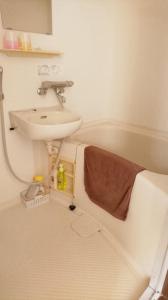 a bathroom with a sink and a toilet and a sink at Weekly Mansion Ise Annex in Ise