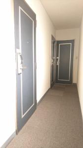 an empty hallway with two doors in a building at Weekly Mansion Ise Annex in Ise
