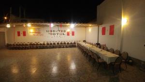 a banquet hall with rows of tables and chairs at Hotel Libertad Pacasmayo in Pacasmayo +32 photos