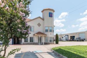 a large white building with a clock tower at Motel 6-Hutchins, TX in Hutchins