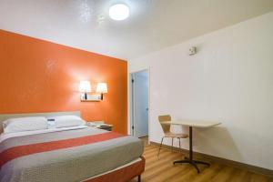a hotel room with a bed and a desk at Motel 6-Lakewood, CO - Denver in Lakewood