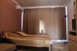 A bed or beds in a room at Verona Apartman
