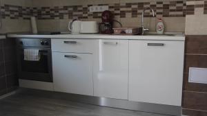 A kitchen or kitchenette at Verona Apartman