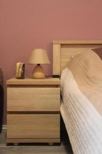 A bed or beds in a room at Verona Apartman