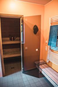a bathroom with a walk in shower next to a room at Krauklis beach apartments in Saulkrasti +58 photos