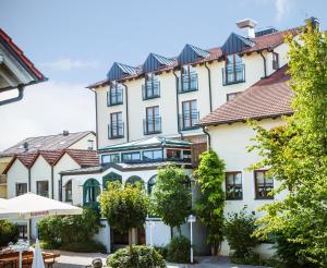 a large white building with black windows at Landhotel Schneider in Riedenburg