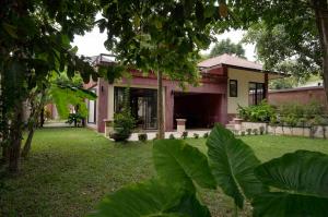 a house with a yard in front of it at Villa Itam in Ko Lanta