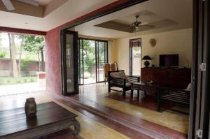 a living room with a couch and a table at Villa Itam in Ko Lanta