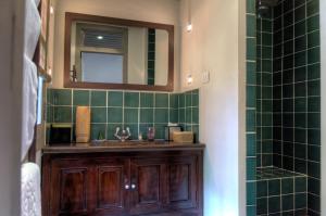 a bathroom with a sink and a mirror at Satri House Hotel in Luang Prabang