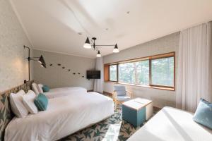 Postel nebo postele na pokoji v ubytování Karuizawa Prince Hotel East