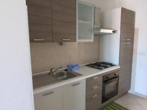 a small kitchen with a sink and a stove at Villa Paladina in Hvar