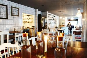 a restaurant with a wooden table with bottles on it at Huskvarna Stadshotell in Huskvarna