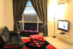 a living room with a couch and a large window at Firina Home in Kuala Lumpur