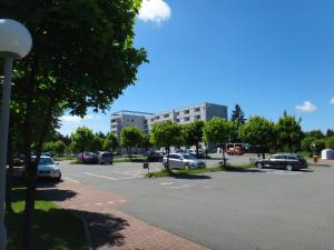 a parking lot with cars parked in a parking lot at Hahnenklee Ferienpark 409 & 211 in Goslar