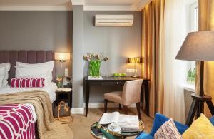 a hotel room with a bed and a desk at Easy Room in Nizhny Novgorod