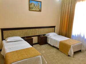 Letto o letti in una camera di Muzaffar Hotel Samarkand