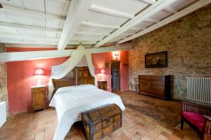 a bedroom with a large bed and a stone wall at Il Granaio in San Venanzo +41 photos