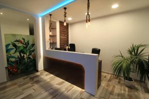 a woman sitting at a reception desk in a office at Hotel Rio Claro in Fondi