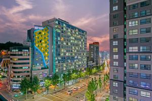 a city with tall buildings and a street at night at H Avenue Hotel Idae Shinchon in Seoul